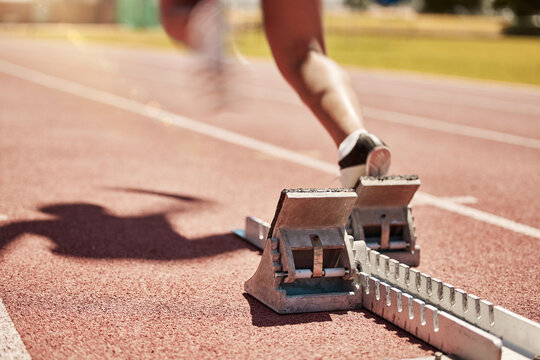 Sports, fitness and running with a start block on a track for a competitive race in a stadium or arena. Health, workout and exercise shoes with a runner at the beginning of a sport competition