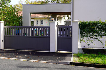 steel grey gate aluminum portal with blades in door suburbs house street