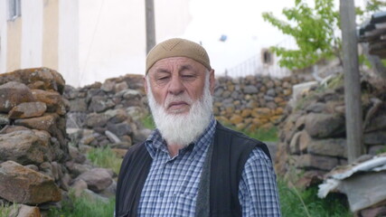 peasant man with white beard, mustache and hat, worried about his future and the harvest