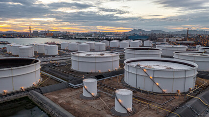 Fototapeta na wymiar Crude oil storage tank terminal port, Oil terminal pipeline fuel storage tank at oil refinery industrial zone in the cargo seaport and ship tanker and storage silo tank at petrochemical terminal port.