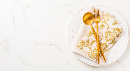 Festive place setting for Christmas or New Year in golden tone