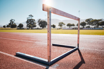 Empty stadium, field and running hurdle or barrier at outdoors race track. Sports, athletics or...