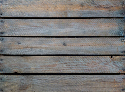 Charming old wooden fruit crate. Image taken from the parallel planks of the bottom, by age discolored to a nice mix of brown and blue shades.