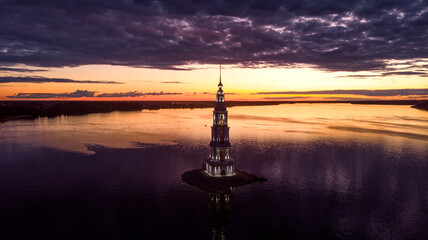 Beautiful view at sunset on Kalyazin Bell Tower in summer in Russia. Flooded Belfry in the middle of the river.