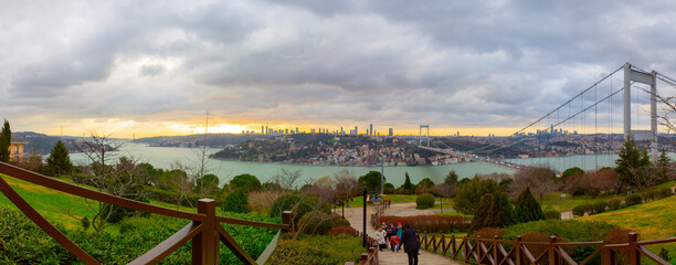 A panoramic view from Otagtepe to the Bosphorus at the sunset.Turkish flag and the FSM Bridge on...