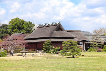 Fototapeta na wymiar Ancient pavilion and stone lantern in Koishikawa Korakuen garden, Okayama, Japan