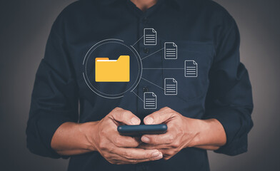 Businessman using smart mobile phones with document Management System (DMS), online documentation database and process automation to efficiently manage files.