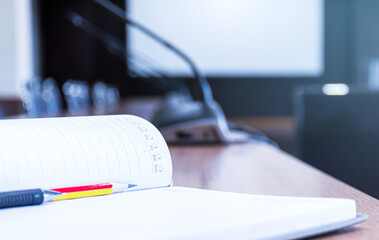 Notebooks with pencil and pen on the table in the meeting room