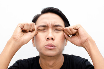 Headshot of young asian man in sad gloomy crying face expression.