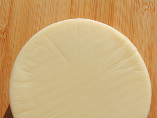 Piece of cheese on a wooden background