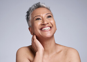 Face, beauty and antiaging with a senior woman in studio on a gray background to promote natural skincare. Wellness, luxury and cosmetics with a mature female posing for dermatology skin treatment