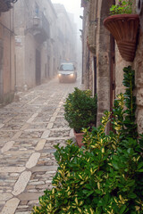 Erice city street in morning fog, Sicily, Italy.