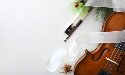 Christmas musical event with violin and decoration on white table