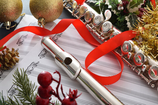 Detail of flute on music sheet ribbon and Christmas decoration