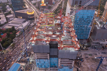 Fototapeta premium aerial view of construction site with tower crane urban construction Rush hour of concrete pouring 