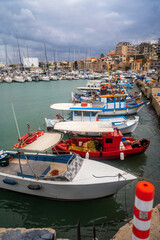 Fototapeta na wymiar Colorful boats in Venetian harbour in Heraklion.