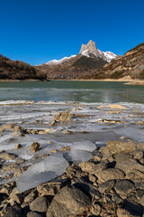 Lanuza reservoir (Huesca), frozen water and first snow in the mountains.