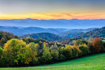 Autumn forest at sunrise with colorful sky. Mountain landscape. Vrsatec, Slovakia.