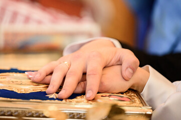 bride and groom hold each other's hands during a church wedding ceremony