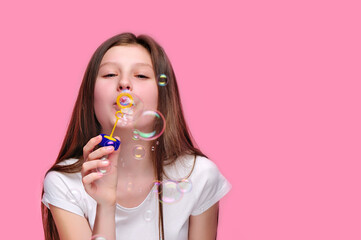 Pretty teen girl blowing bubbles