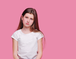 Fototapeta premium Sad brunette teen girl against pink background