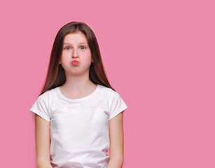 Fototapeta premium Teen brunette girl puffing out her cheeks