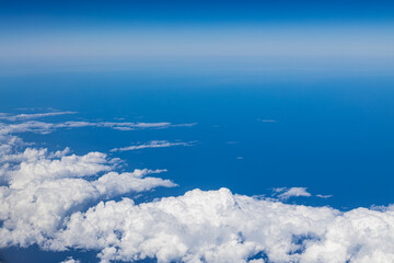 Naklejka na ściany i meble Skyline View above the Clouds from air plane