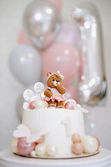 Fototapeta na wymiar Baby First Birthday Cake with a Bear figurine