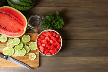 Fresh ingredients for making watermelon drink with lime on wooden table, above view. Space for text