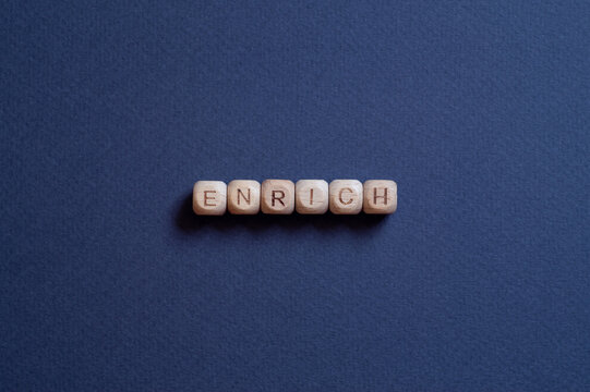 Enrich - word concept on cubes