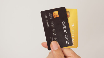 Hand is hold black and gold credit card on white background.Two credit card..