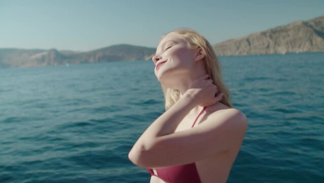 Cover girl is teetering on the edge of a yacht