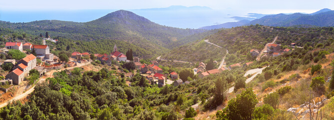 Velo Grablje, historic village on Hvar island in Croatia famous for lavender, vine and olive oil production. Panoramic banner image. Panorama, eerial view from mountain road. Bird view on old houses.