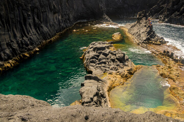 Natural swimming pool between volcanic rocks on Sao Jorge, Azores, Portugal. 