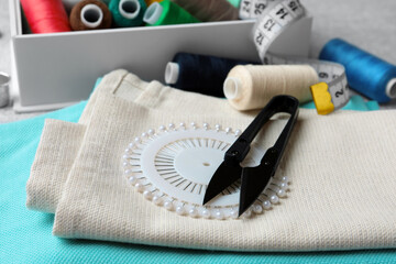 Spools of threads and sewing tools on table