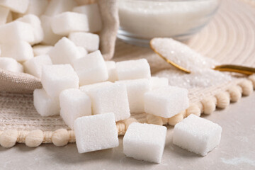 White sugar and wicker mat on light marble table, closeup