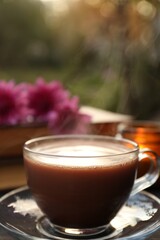 Glass cup with coffee on wooden table. Morning ritual