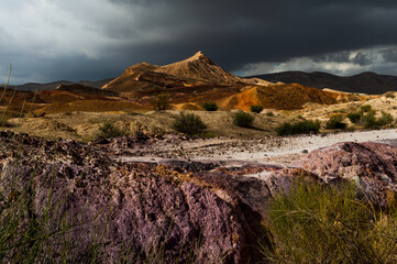 Dark clouds hover over the mineral-rich Colored Sands Nature Reserve in the Negev Desert in southern Israel.