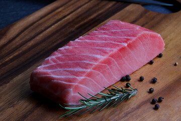 Raw Bluefin Tuna steak on wooden.