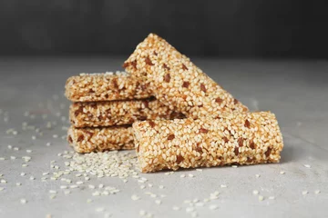Foto op Canvas Tasty sesame seed bars on grey table © New Africa