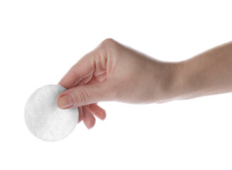 Woman holding soft clean cotton pad on white background, closeup