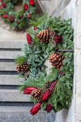 winter christmas wreath decorated by natural flowers, plants and cones