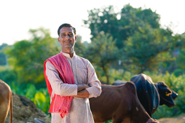 Rural scene : Indian farmer standing his dairy farm