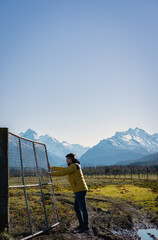 Fototapeta na wymiar Man pushing bars of farm in the mountainside in winter sunny day.
