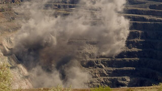 Gray smoke after an explosion in a mining quarry