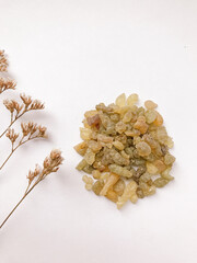 Set of natural resins and twigs of dried flowers , frankincense on white background

