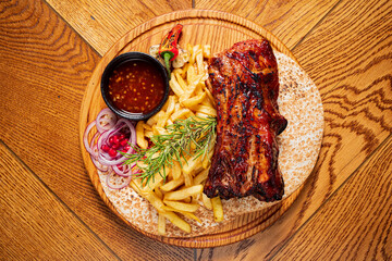 grilled ribs with french fries and sauce