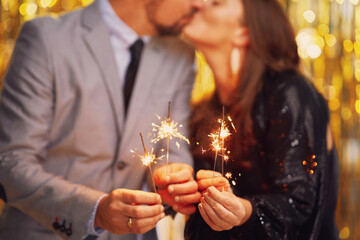 Couple at new year eve party with 2023 sparklers