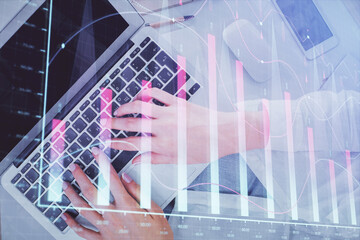 Double exposure of woman hands working on computer and forex chart hologram drawing. Top View. Financial analysis concept.