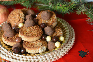 Christmas cookies on a plate on a decorated table. Dessert of cookies plate perfect for celebrating Christmas.